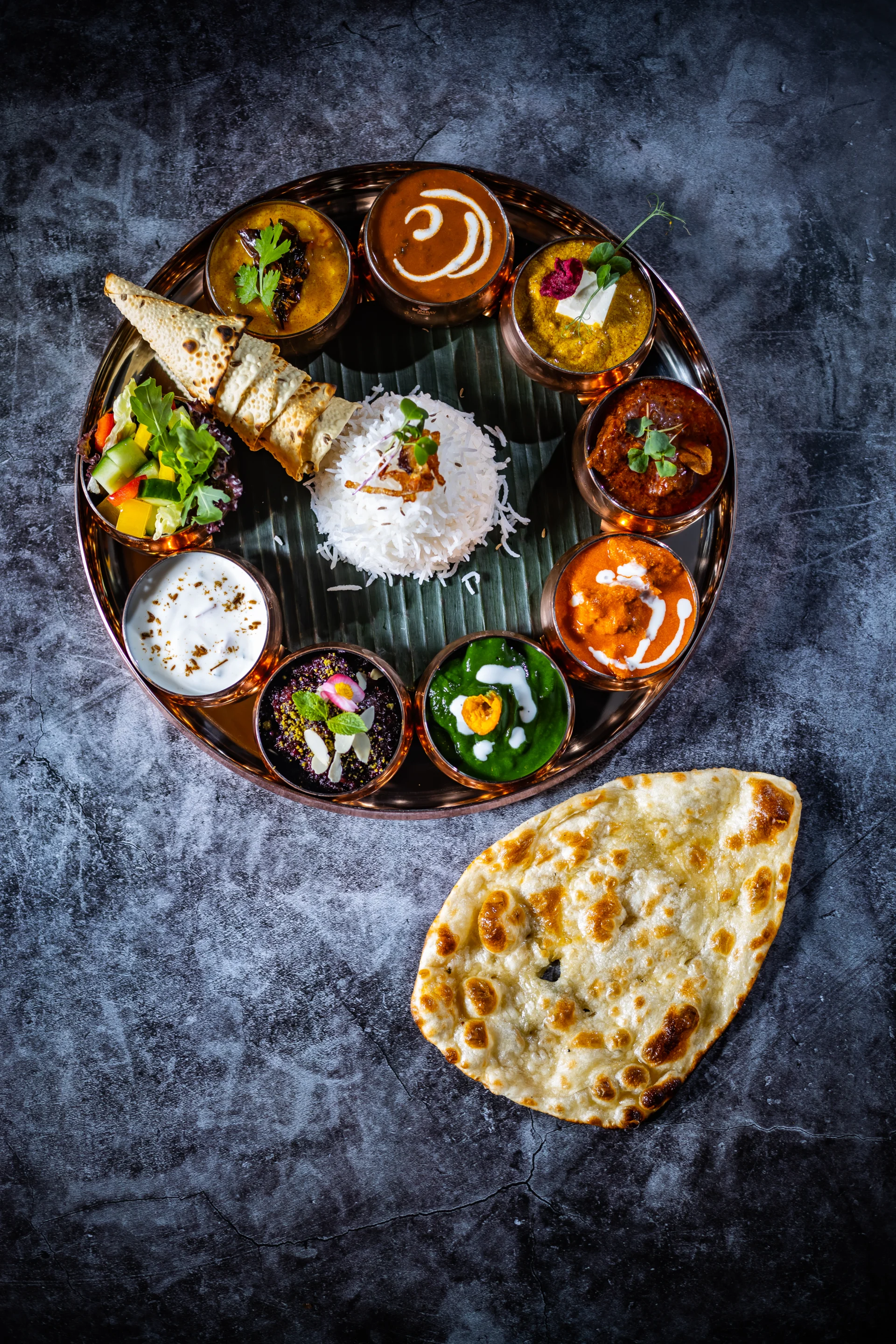 What is a thali, and why does it have nine items?