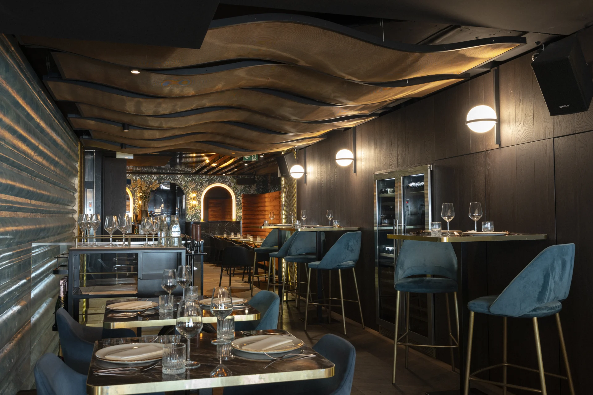 The restaurant dining room beside the bar counter, with a dark interior