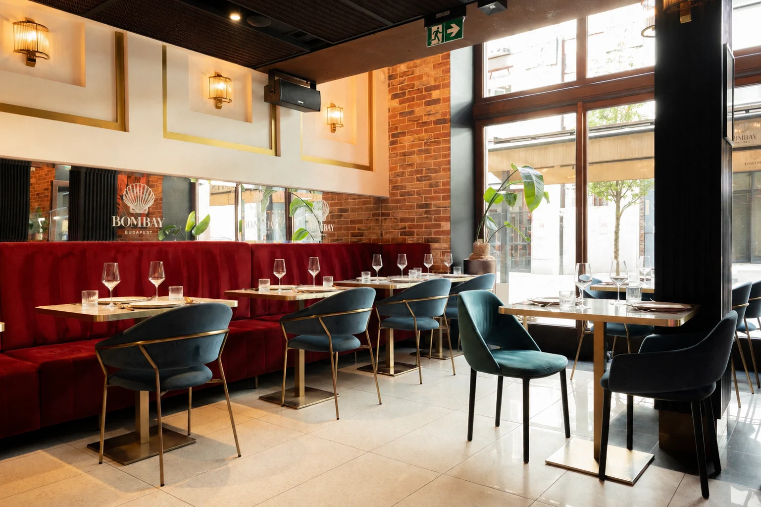 The ground-floor dining room with its street-facing windows and red velvet benches